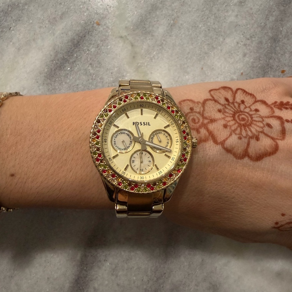 Gold Fossil Watch with multi color diamonds